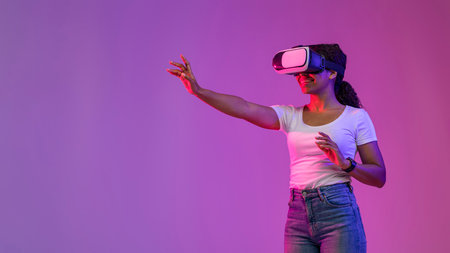 Virtual Experience. Smiling Black Lady Playing Video Game In VR Headsetの写真素材