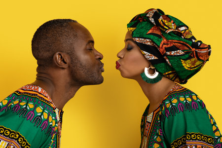 Closeup of loving black couple kissing on yellow