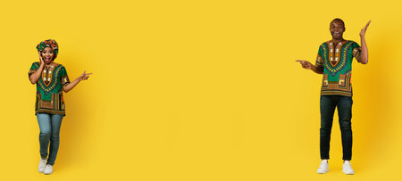 Emotional black couple in traditional costumes showing copy spaceの写真素材