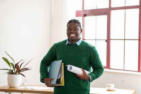 Happy African American Architect Man Standing Holding Folders In Office
