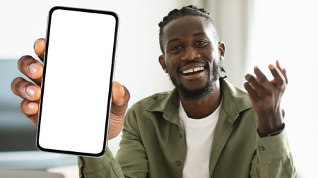 Happy Black Man With Dreadlocks Showing Big Blank Smartphone With White Screenの写真素材