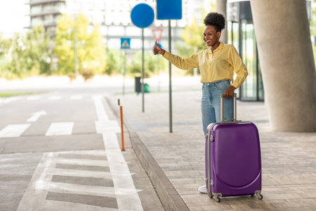 African American Tourist Lady Stopping Taxi With Gesture Near Airportの写真素材