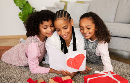 Cheerful African American Daughters Congratulating Their Mom At Home