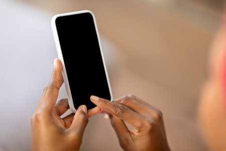Cropped of black woman touching smartphone blank screenの写真素材