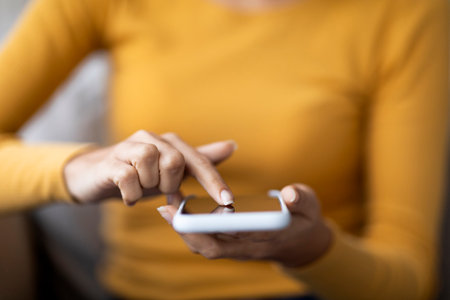 Unrecognizable Female Touching Screen Of Modern Smartphone With Finger