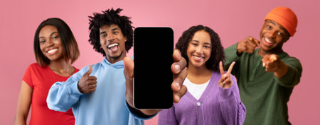 Cheerful millennial black people show smartphone with empty screen and show thumb up, approving app