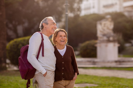 Cheerful Senior Travelers Couple Standing Looking Aside In Park Outdoorsの写真素材