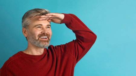 Smiling middle aged man looking at copy space