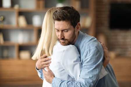 Grateful Patient. Young Man Hugging Doctor Woman During Meeting In Officeの写真素材