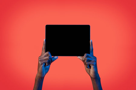 male hands holding digital pad with empty black screenの写真素材