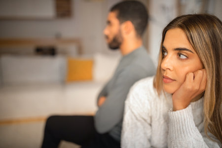 Sad offended international millennial couple think about divorce after quarrel in living room...