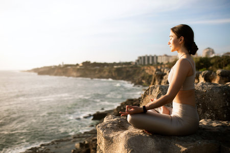 Glad calm slim millennial european female in sportswear practicing yoga, enjoy training, meditating and sunriseの写真素材