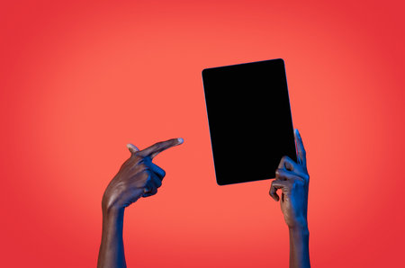 Unrecognizable black man pointing at digital tablet with black screenの写真素材