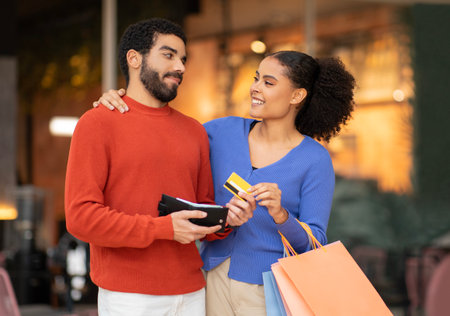 Husband Giving Credit Card To Wife Shopping At Mallの写真素材