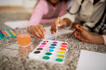 Black Mom And Daughters Drawing Using Paint Brushes Indoor, Croppedの写真素材