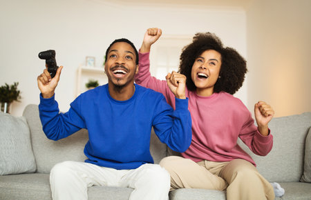 Joyful African American Couple Playing Game Having Fun At Homeの写真素材