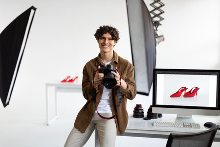 Photographer checking the shot on computer, man working with stylish shoes, enjoying result after content photoshootの写真素材