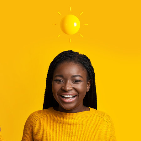 Headshot of happy teen african america lady with abstract sun above her headの写真素材