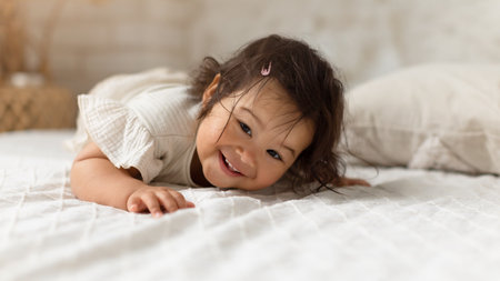 Adorable Korean Baby Infant Girl Smiling Lying In Bedroom, Panoramaの写真素材