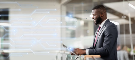 Cheerful handsome confident african american millennial businessman ceo with beard use tabletの写真素材