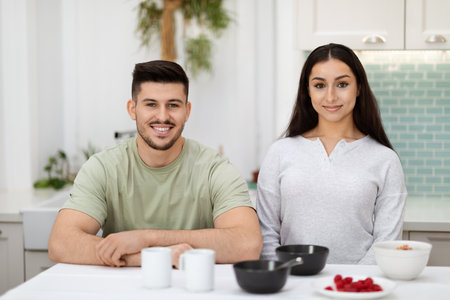 Portrait of happy loving couple have breakfast together in kitchenの写真素材