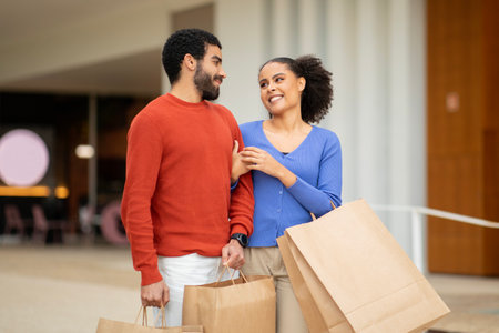 Cheerful Diverse Spouses Shopping On Weekend Walking Holding Bags Outside