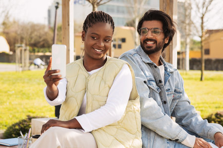 Cheerful millennial different modern students look at smartphone camera, have video call, selfieの写真素材