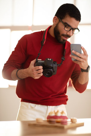 Young man food influencer taking photo of dessertの写真素材