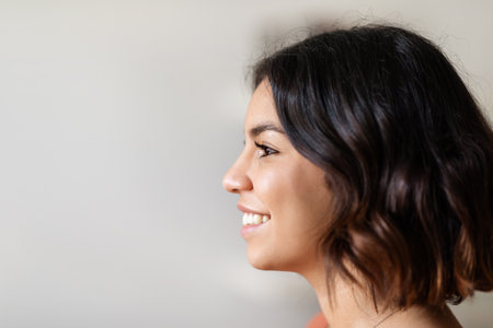 Profile Shot Of Beautiful Smiling Young Arab Woman Standing Indoors