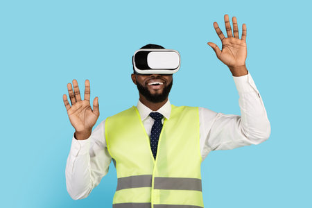 Excited Black Builder Man Wearing VR Glasses Standing On Blue Background,