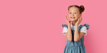 Portrait of surprised little girl touching face with excitement and looking asideの写真素材