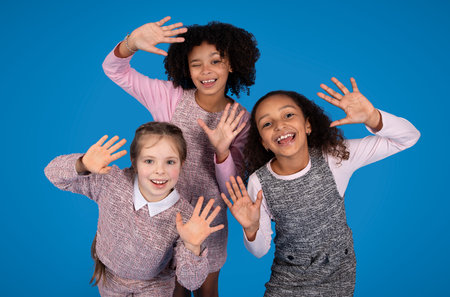 Happy teen african american and caucasian girls have fun, enjoy free time togetherの写真素材