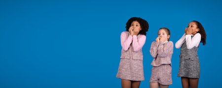 Shocked scared teenage african american and caucasian girls looking at free spaceの写真素材