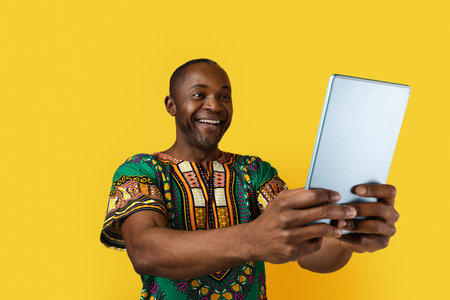 Happy middle aged black man holding digital tabletの写真素材