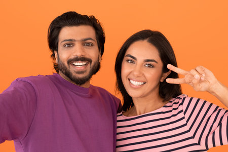 Beautiful eastern young couple taking selfie togetherの写真素材