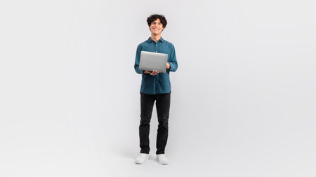 Guy Holding Laptop Surfing Web On Light Gray Backgroundの写真素材