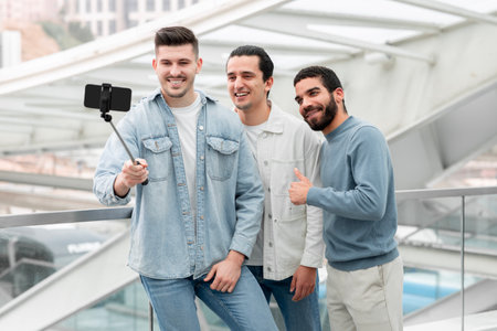 Three Travelers Guys Making Selfie Sharing Travel Moments At Stationの写真素材