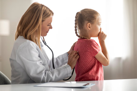 Children Healthcare. Female Pediatrician Doctor Examining Coughing Little Girl Patient With Stethoscopeの写真素材