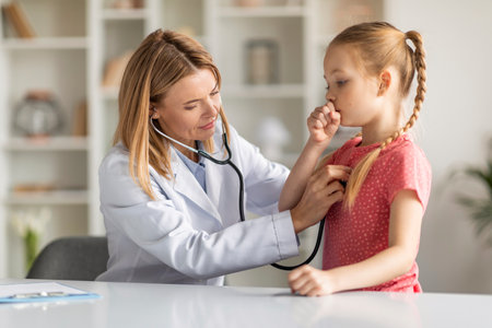 Pediatrician Lady With Stethoscope Listening Lungs Of Coughing Little Girl During Checkupの写真素材