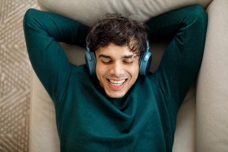 Top View Of Guy Wearing Headphones Enjoying Music At Homeの写真素材