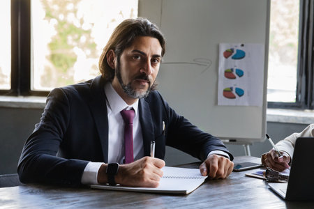 Handsome middle eastern man CEO manager singing papers