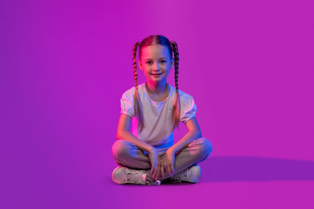 Cute pretty little girl chilling on luminous backgroundの写真素材