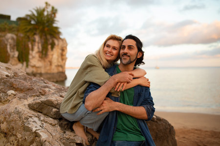 Portrait Of Romantic Young Couple Embracing On The Beach At Sunset Timeの写真素材