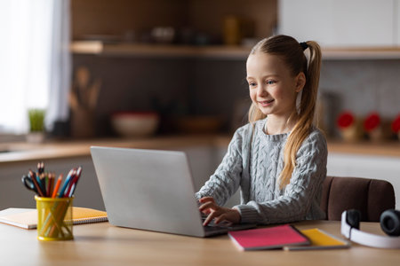 Cute Little Schoolgirl Study With Laptop At Home, Typing On Computer Keyboardの写真素材