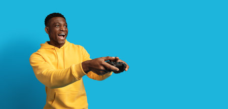 Thrilled african american man playing video games with joystick, panorama