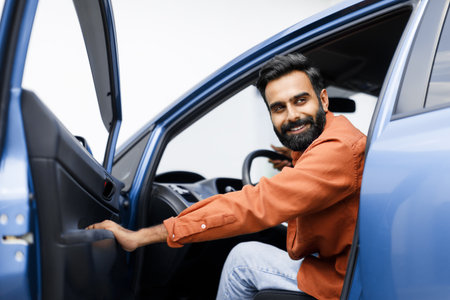 Happy Arabic Man Opening Automobile Door Sitting In New Vehicleの写真素材