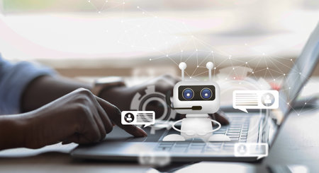 Unrecognizable african american businesswoman typing on laptop keyboard, using chatbotの写真素材