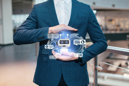 Cropped of businessman holding Chatbot virtual icon, collageの写真素材