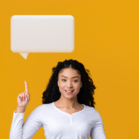 African Lady Pointing At Blank Text Bubble Icon, Yellow Background