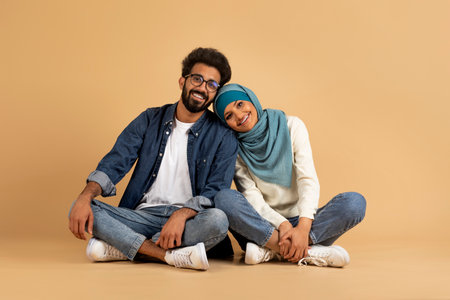 Happy Romantic Muslim Couple Posing Together Over Beige Studio Background,の写真素材